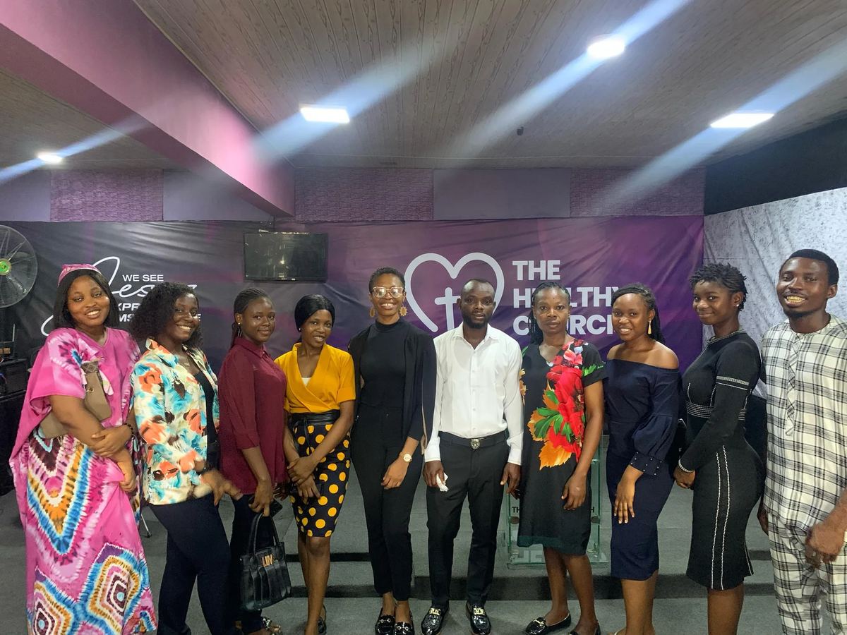 The team standing together in front of The Healthy Church backdrop