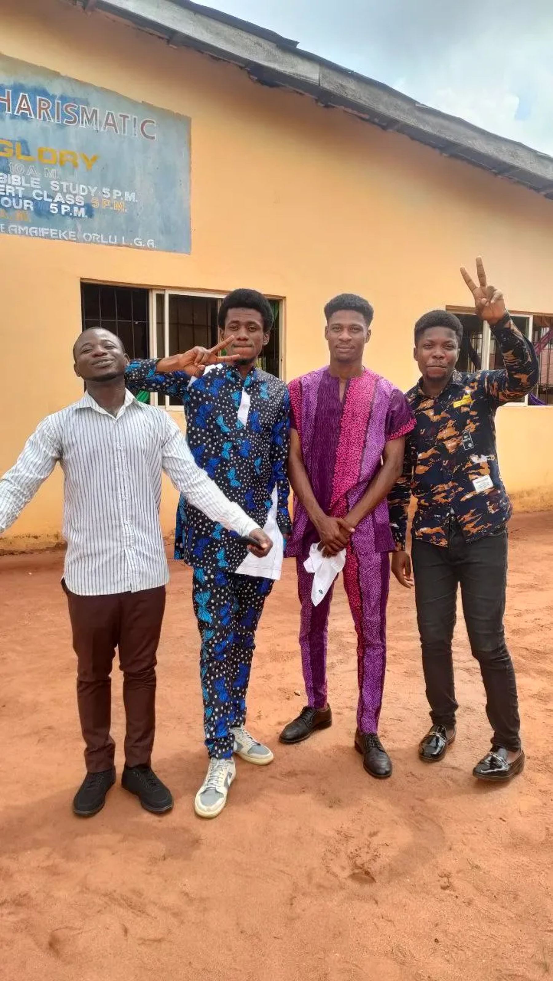 Four team members outside the church building