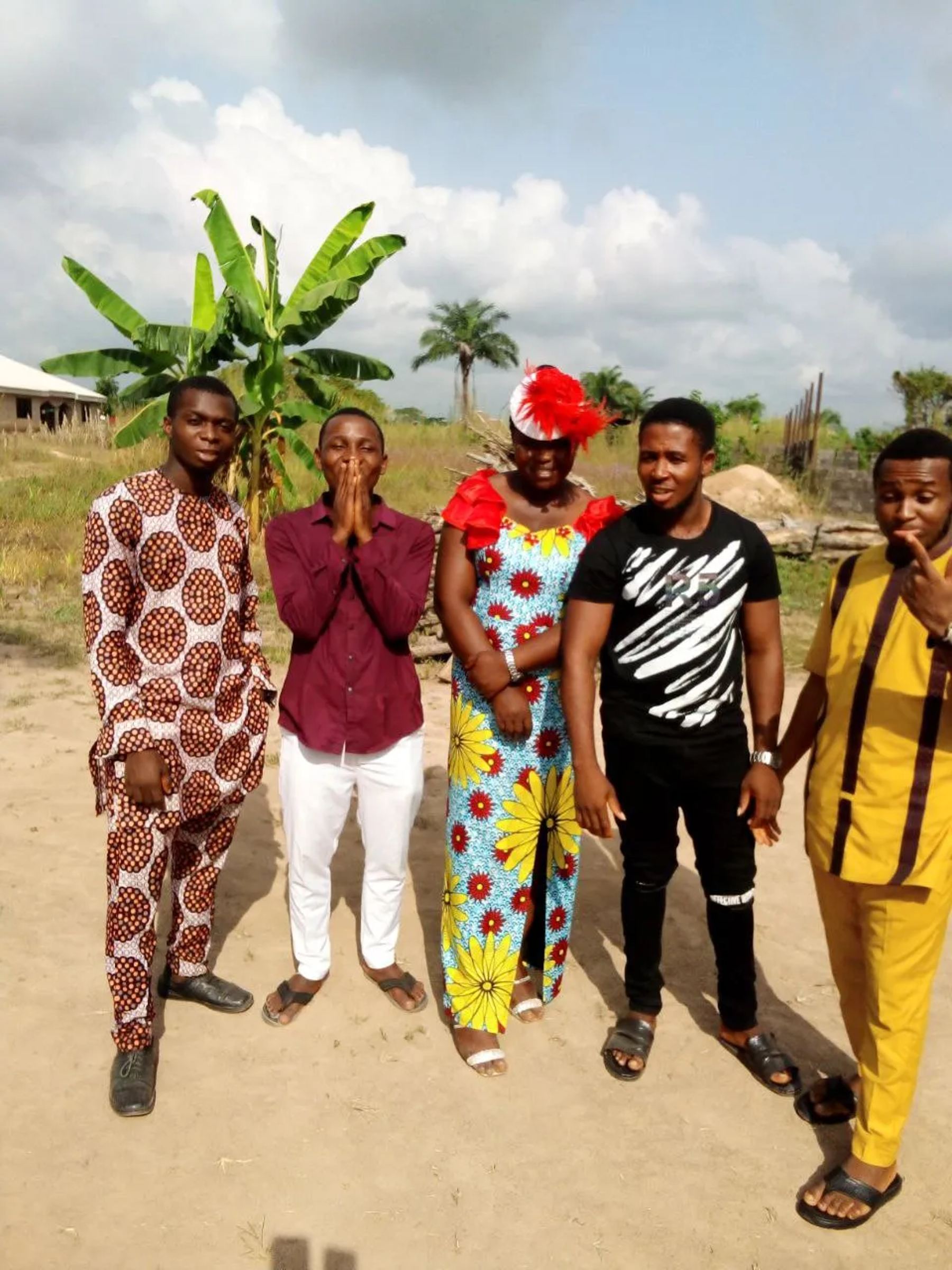 Five team members standing together outdoors