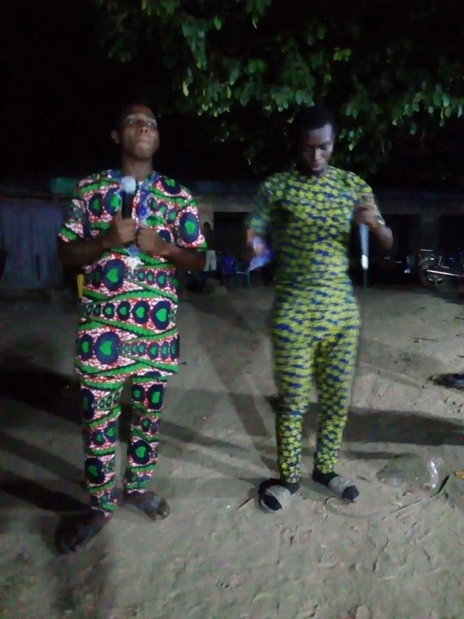 Two team members ministering at night