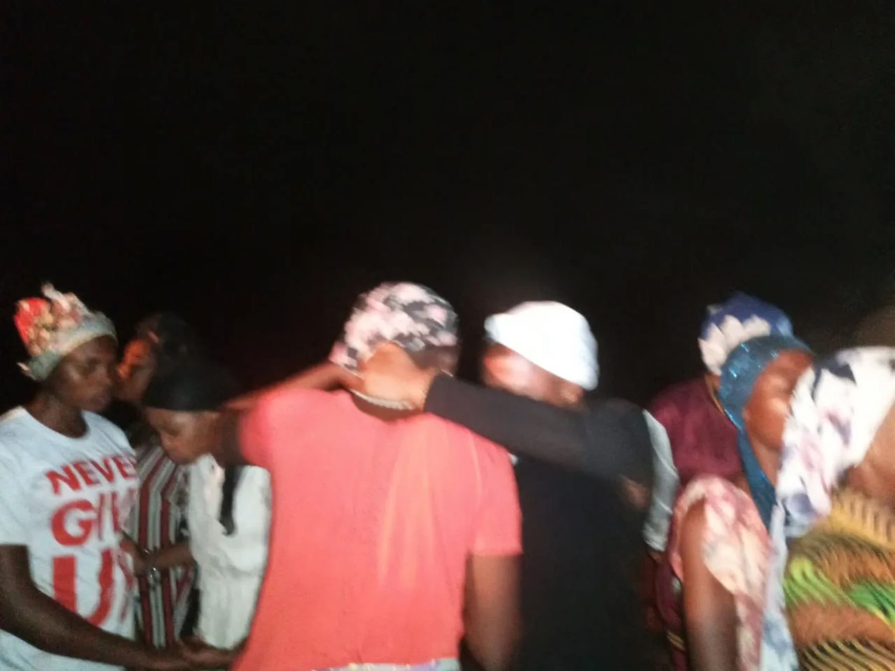 Women praying together at night