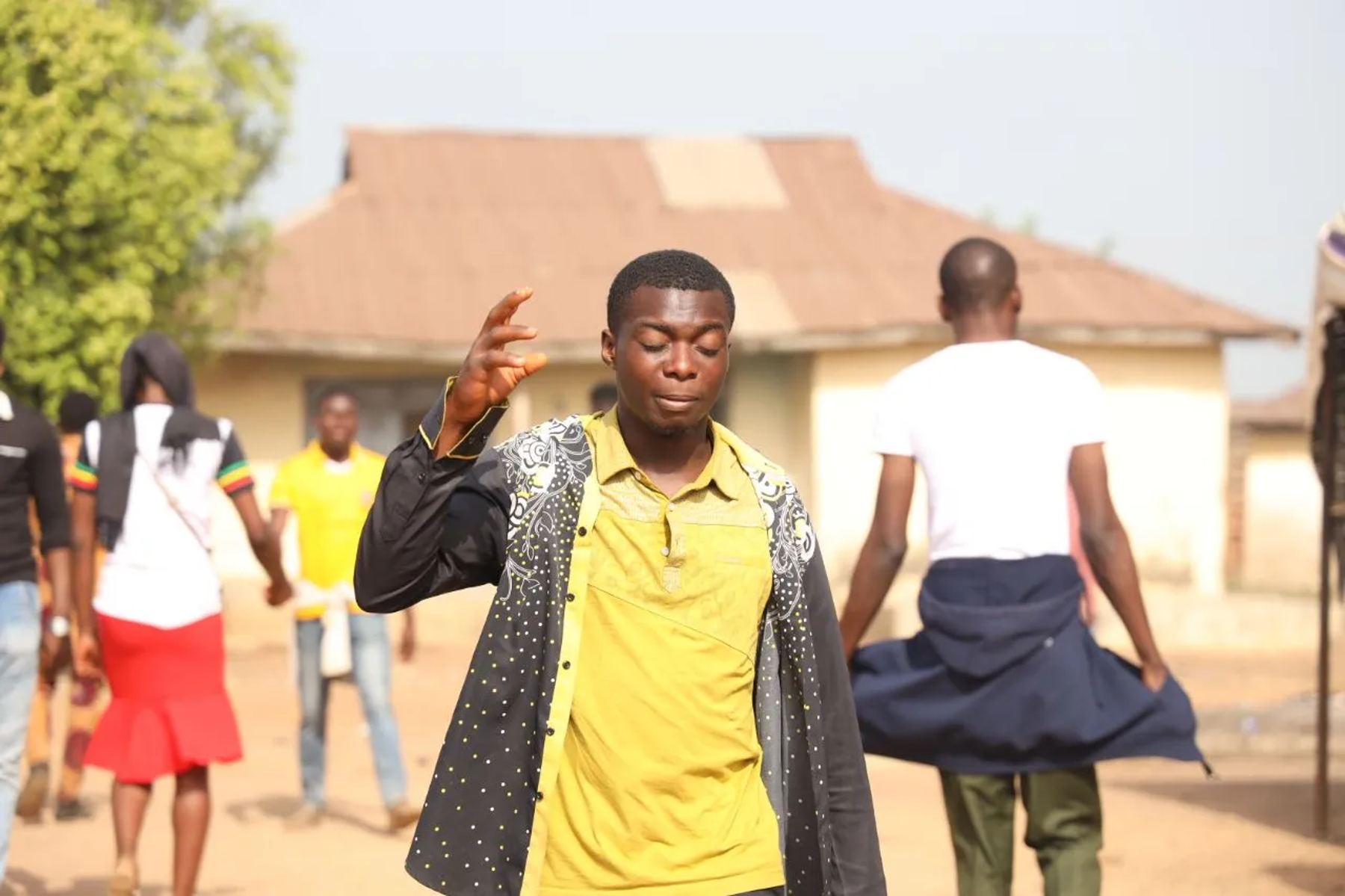 A young man praying in the street