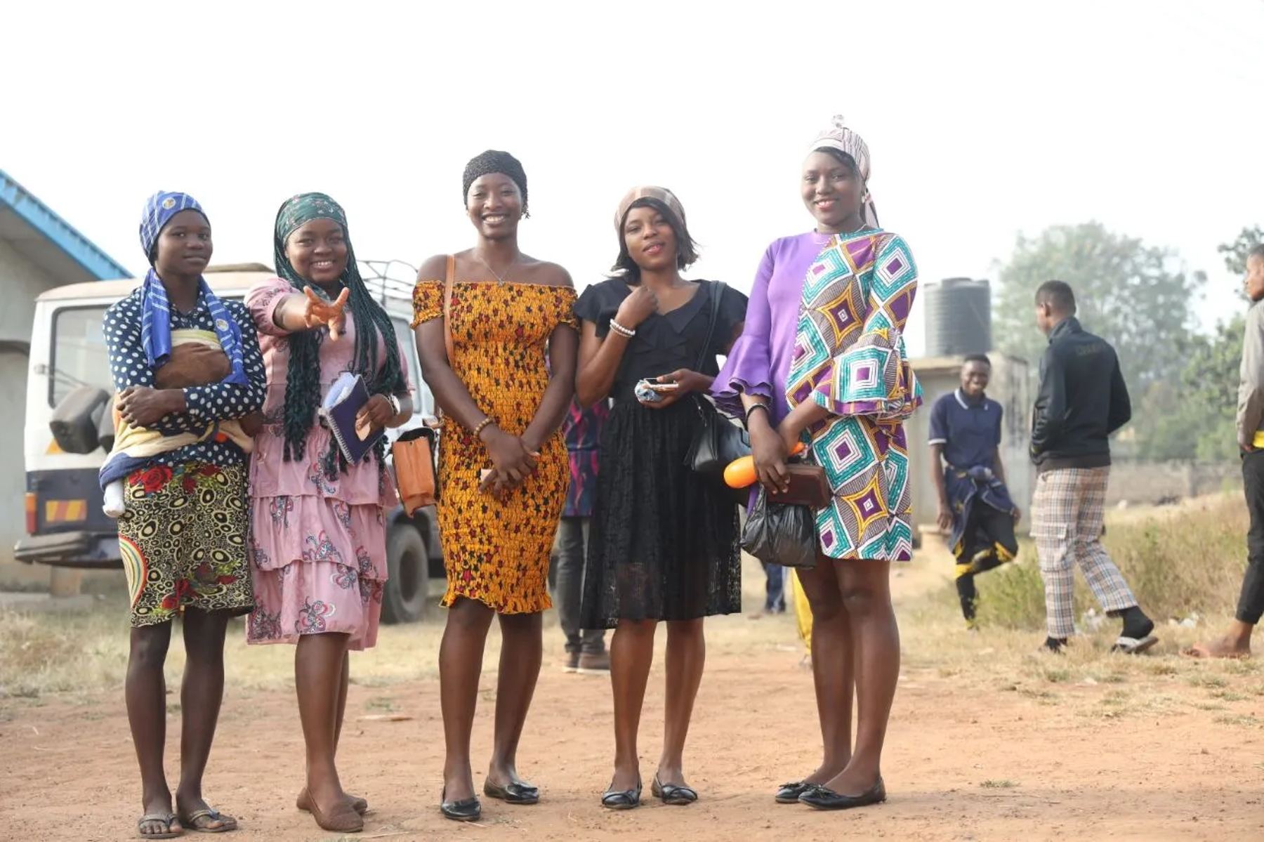 Five young women standing together outdoors