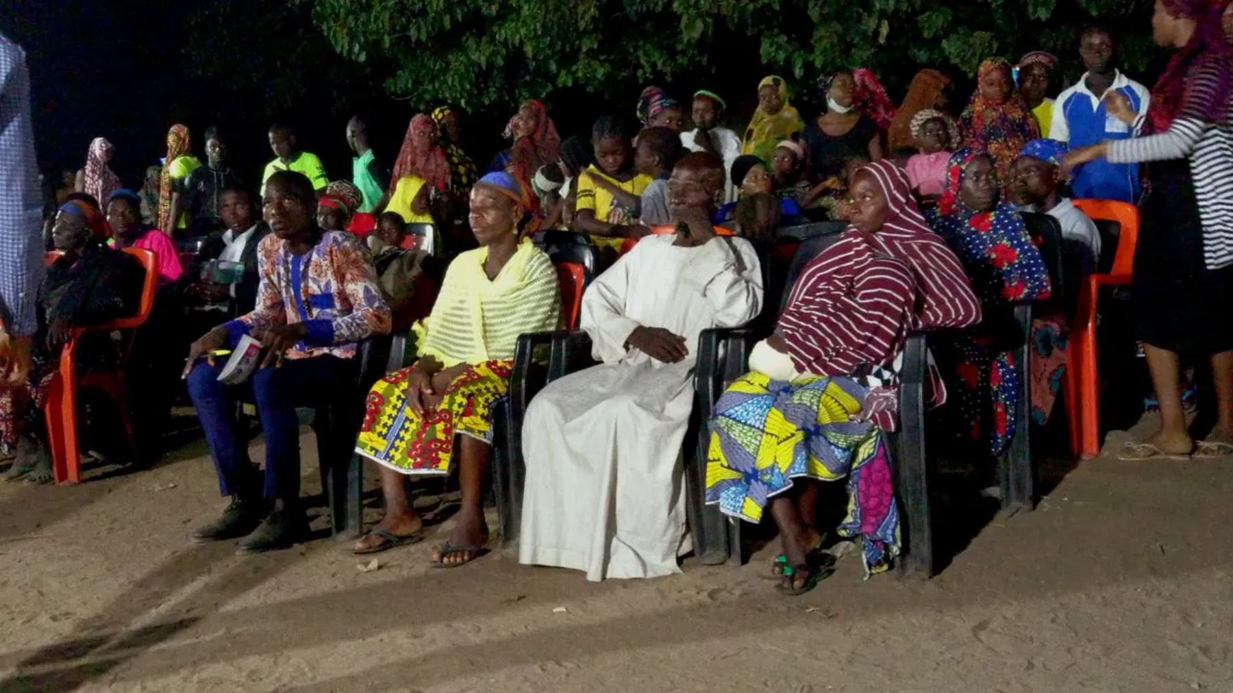Women and men seated at the night meeting