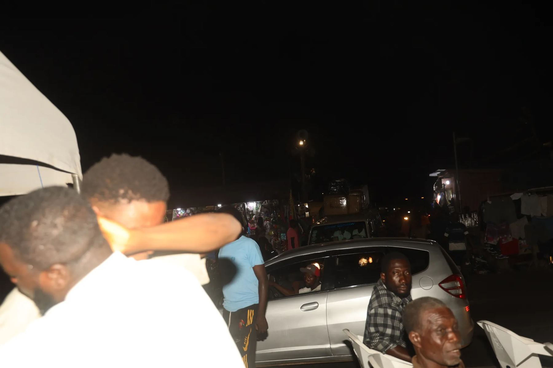 Team members praying together at night beside the street