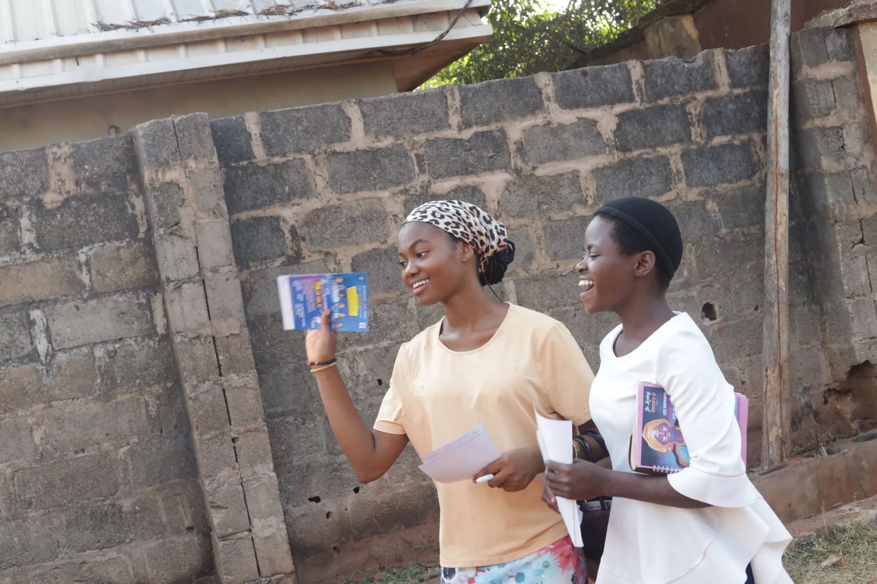 Two young women walking the street with tracts