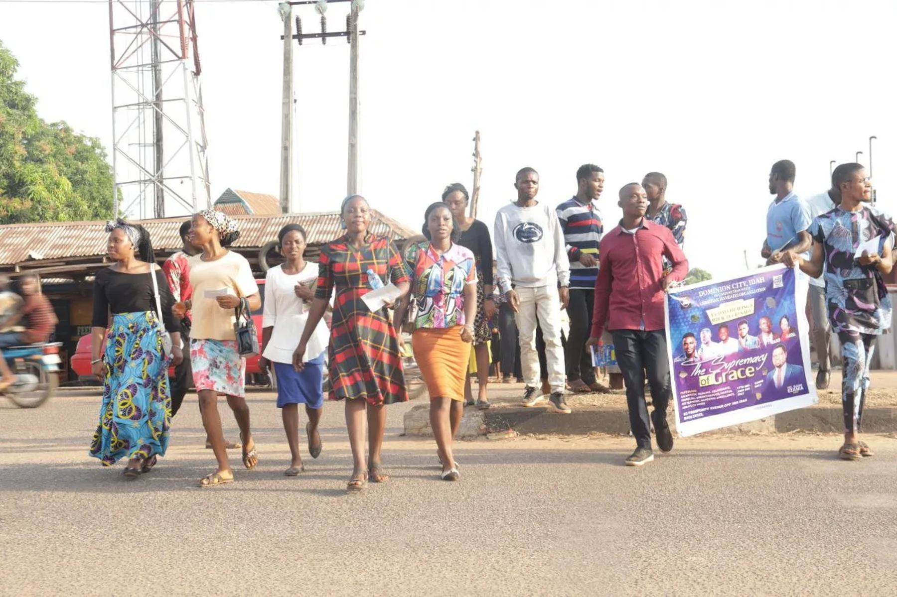 The team walking along the road with a banner