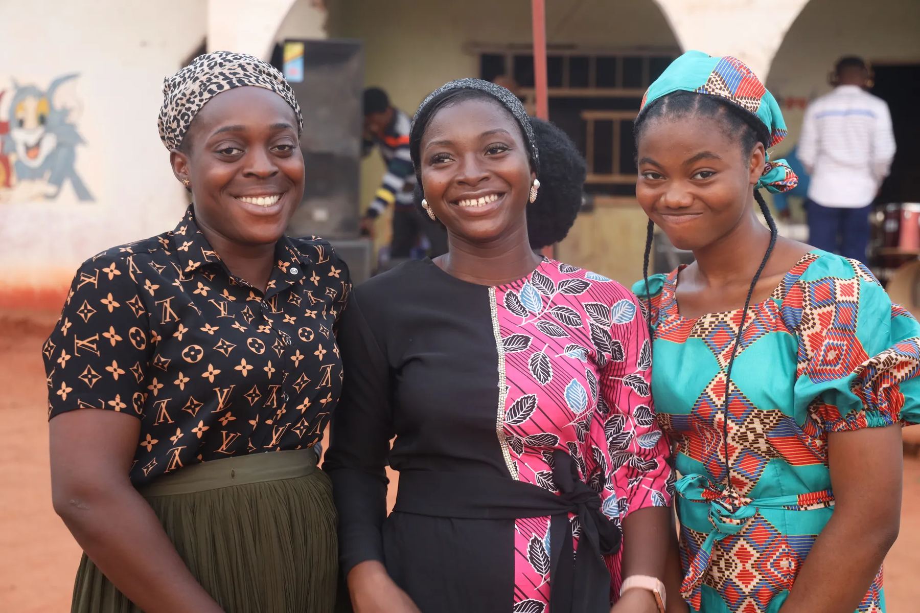 Three young women smiling together