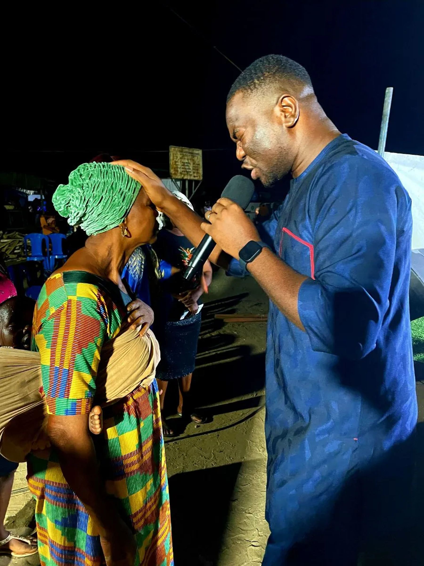 A minister praying for a woman at the night outreach