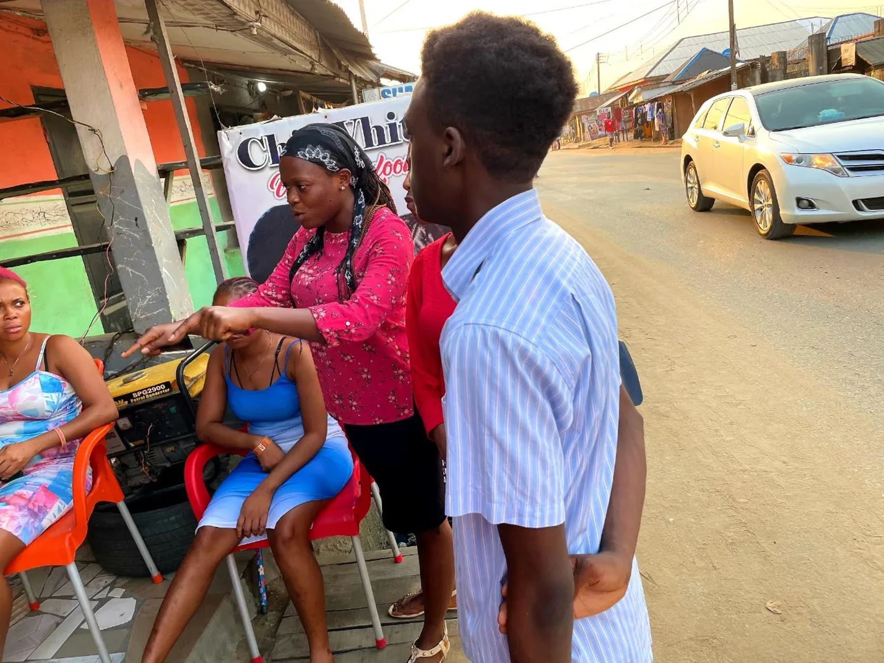 Team members sharing the gospel with women at a roadside shop