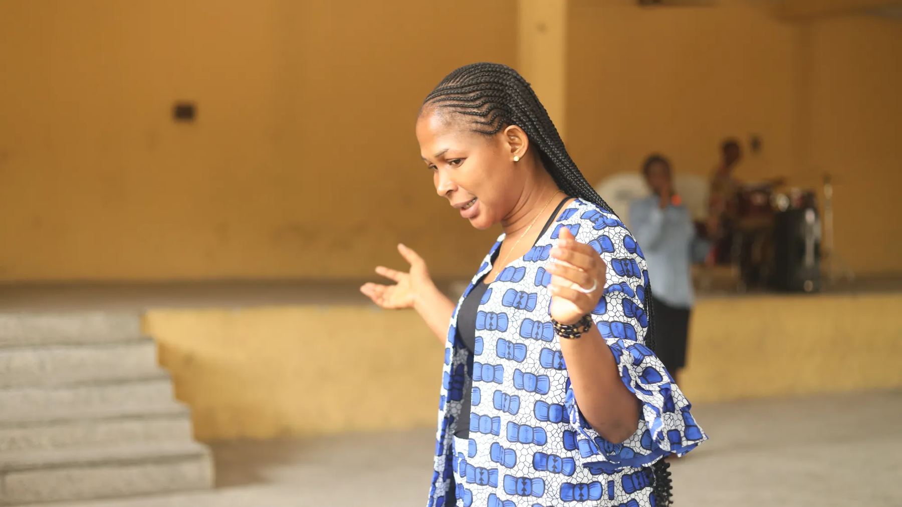 A woman preaching in a hall