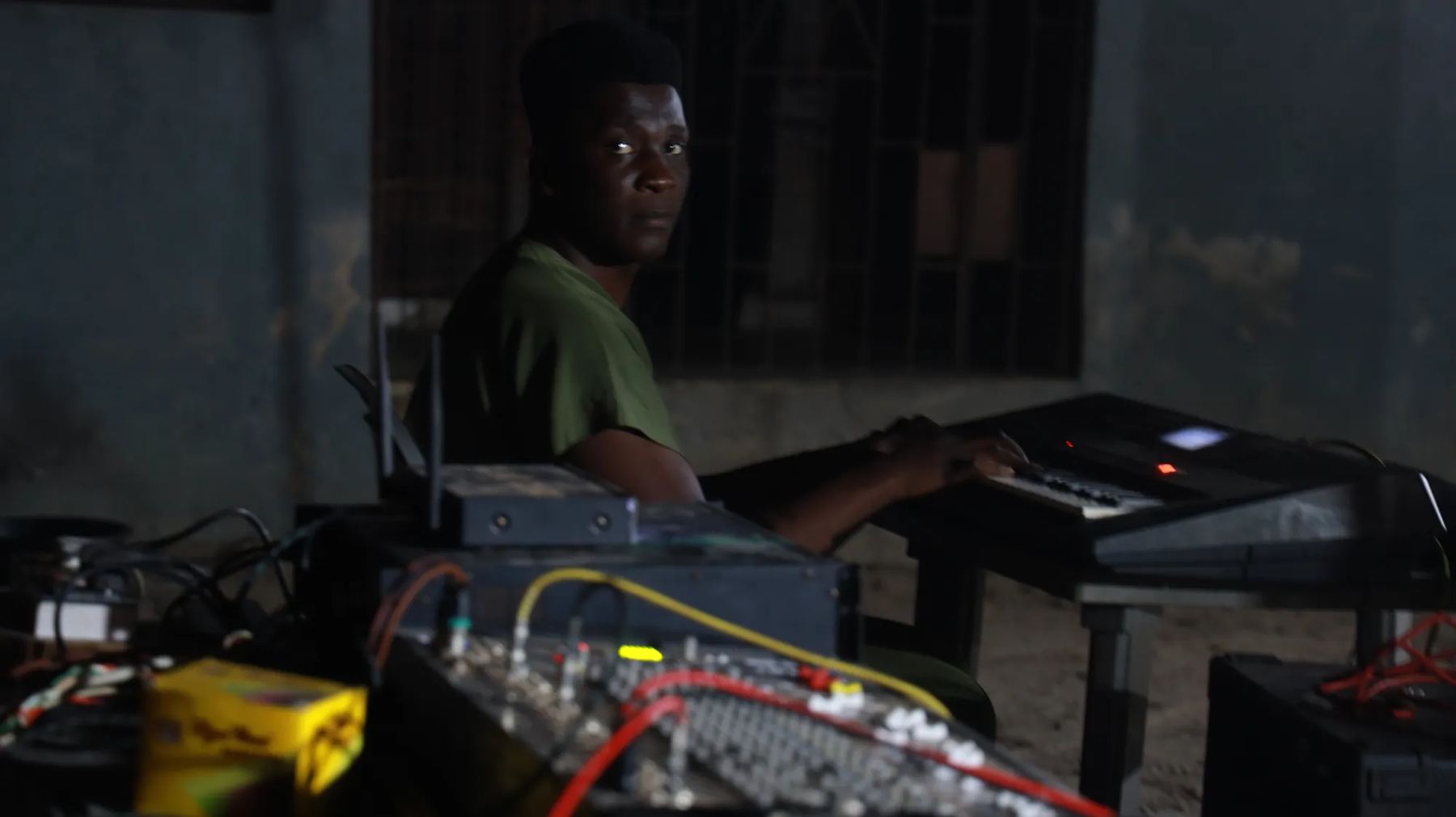 A keyboardist at the sound desk