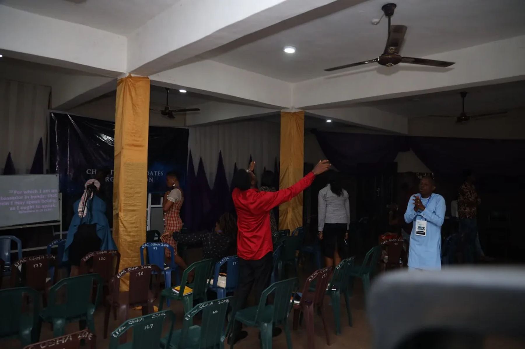 Participants praying in the hall