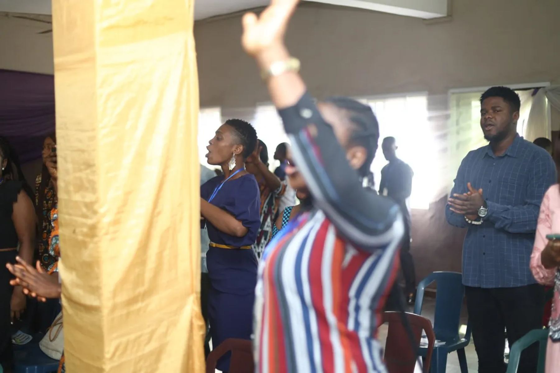 Participants worshipping in the hall
