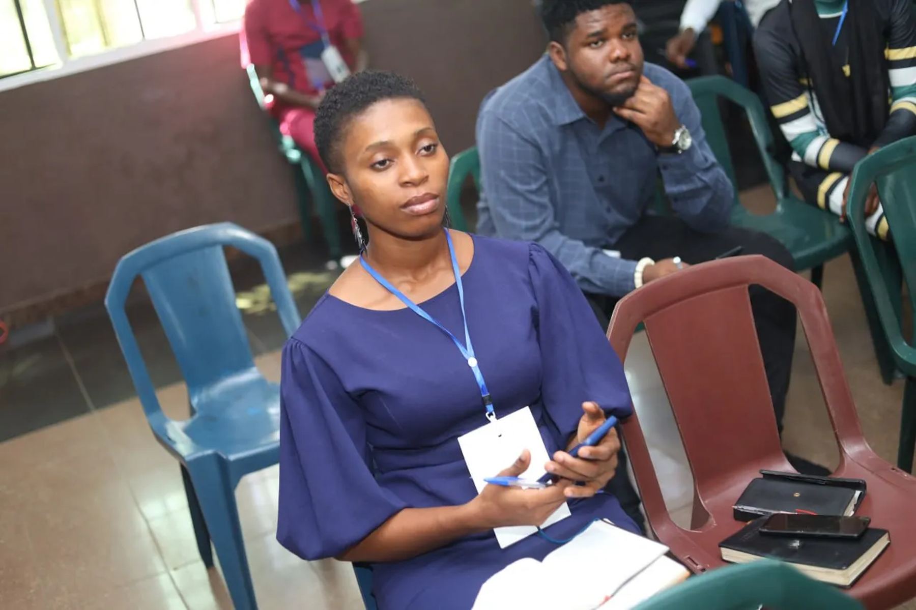 Two participants seated, listening