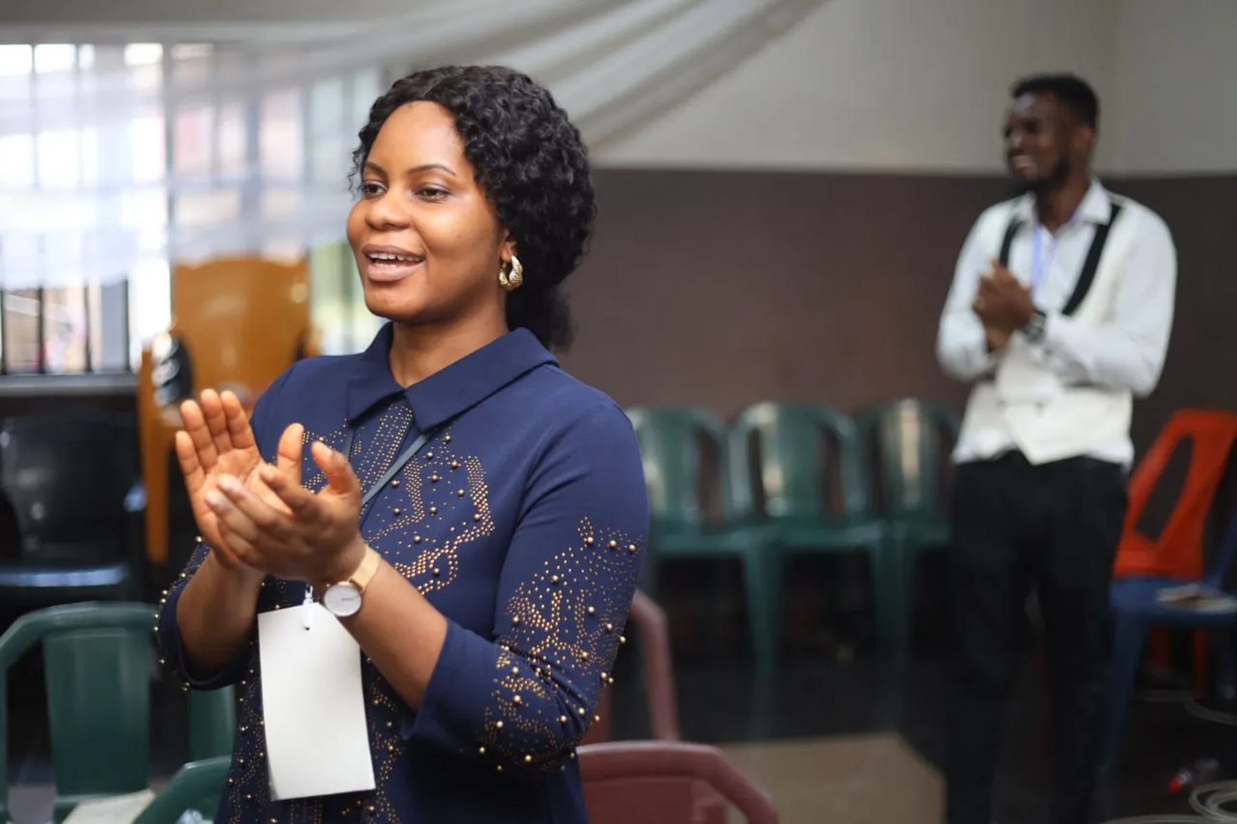 A participant clapping in worship