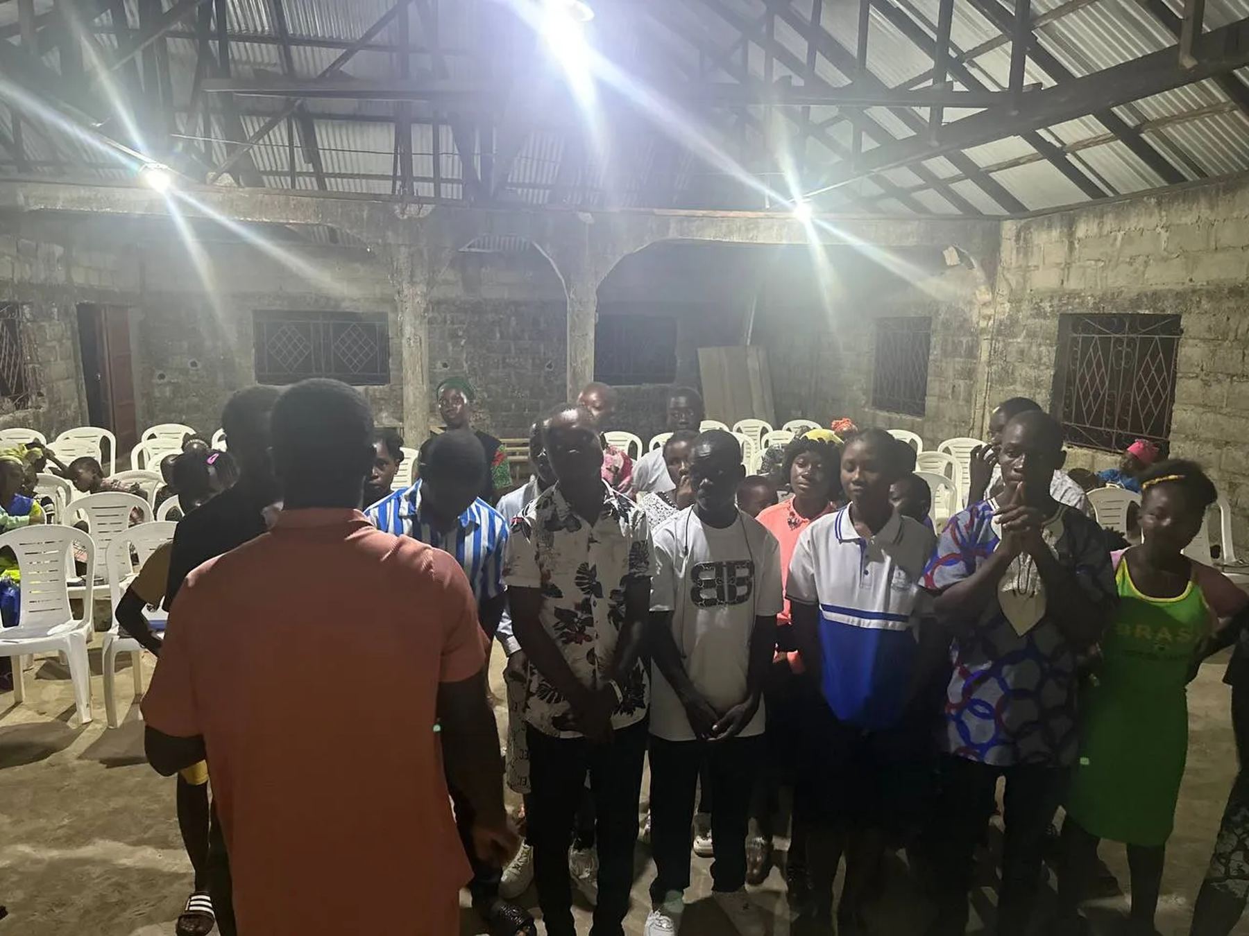 A group of young people standing together in the church hall