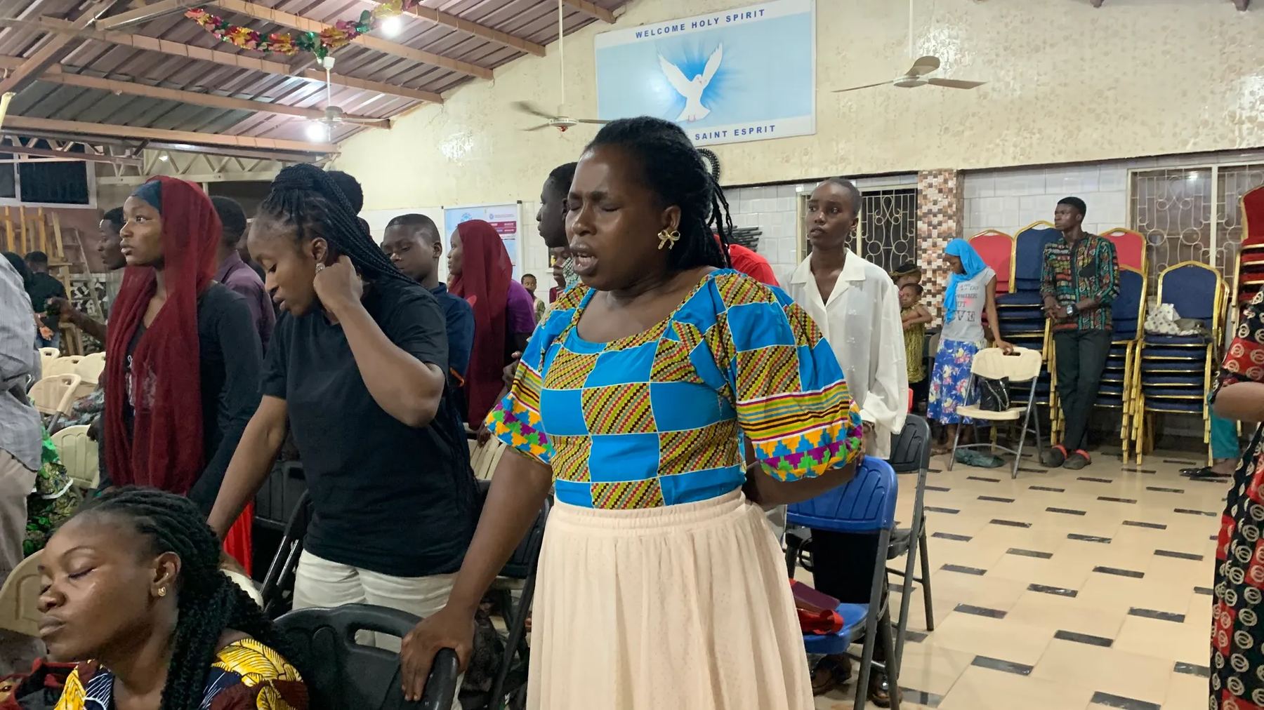 Women praying with their eyes closed