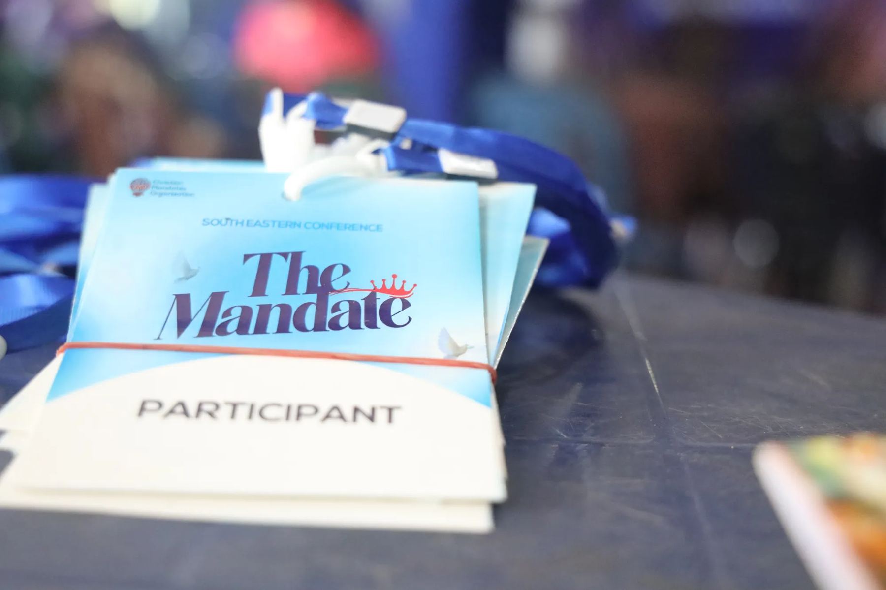 Participant badges for the South Eastern Conference, themed The Mandate, on a table
