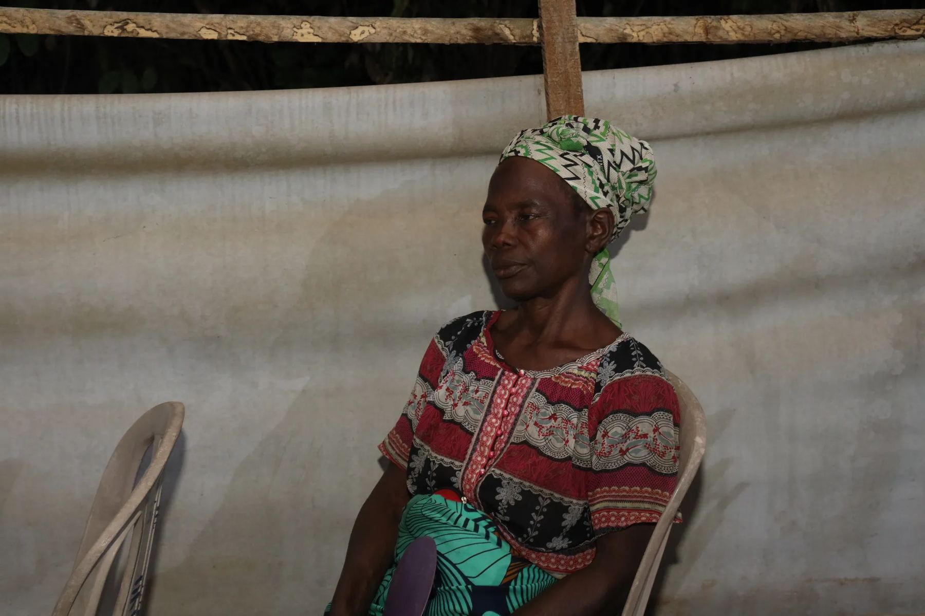 A woman in a head wrap seated at the meeting