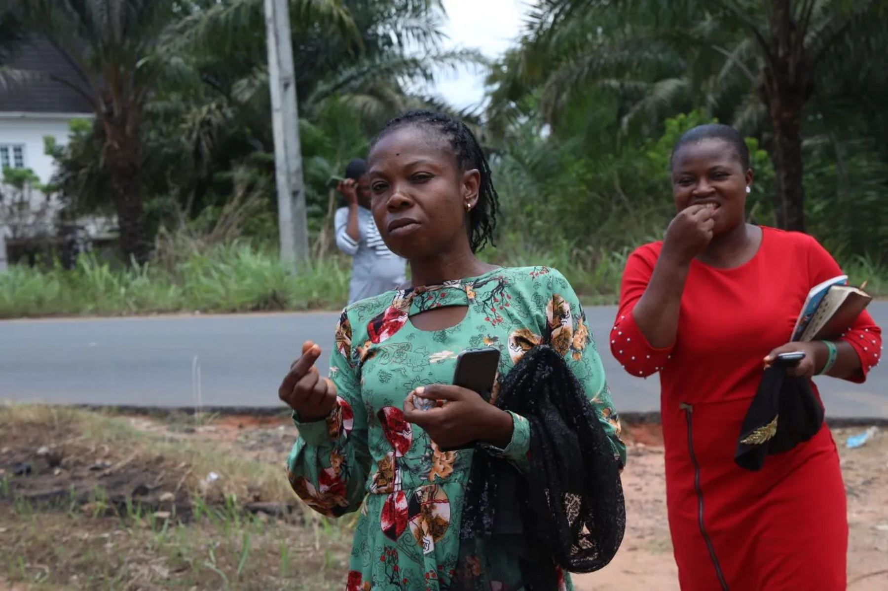 Two women on the road holding Bibles