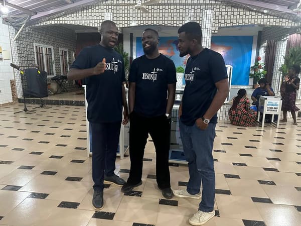 Three team members in Jesus T-shirts standing in the hall